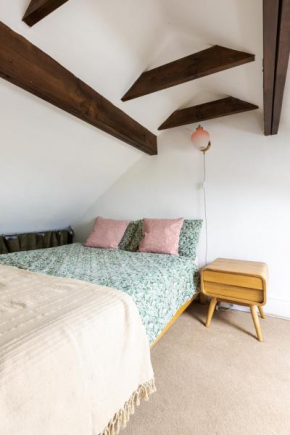 En-suite with double bed on mezzanine and desk in family home